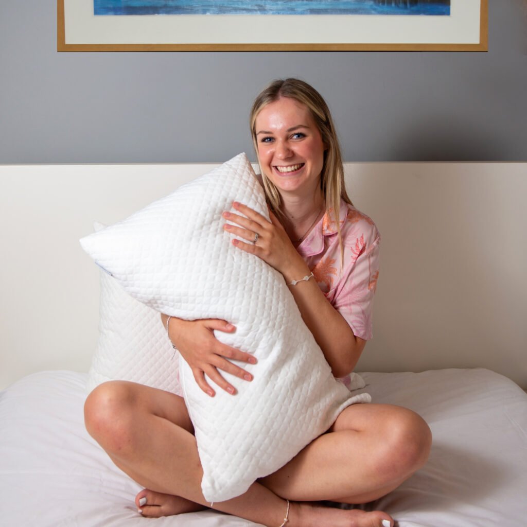 Girl hold pillow and smiling